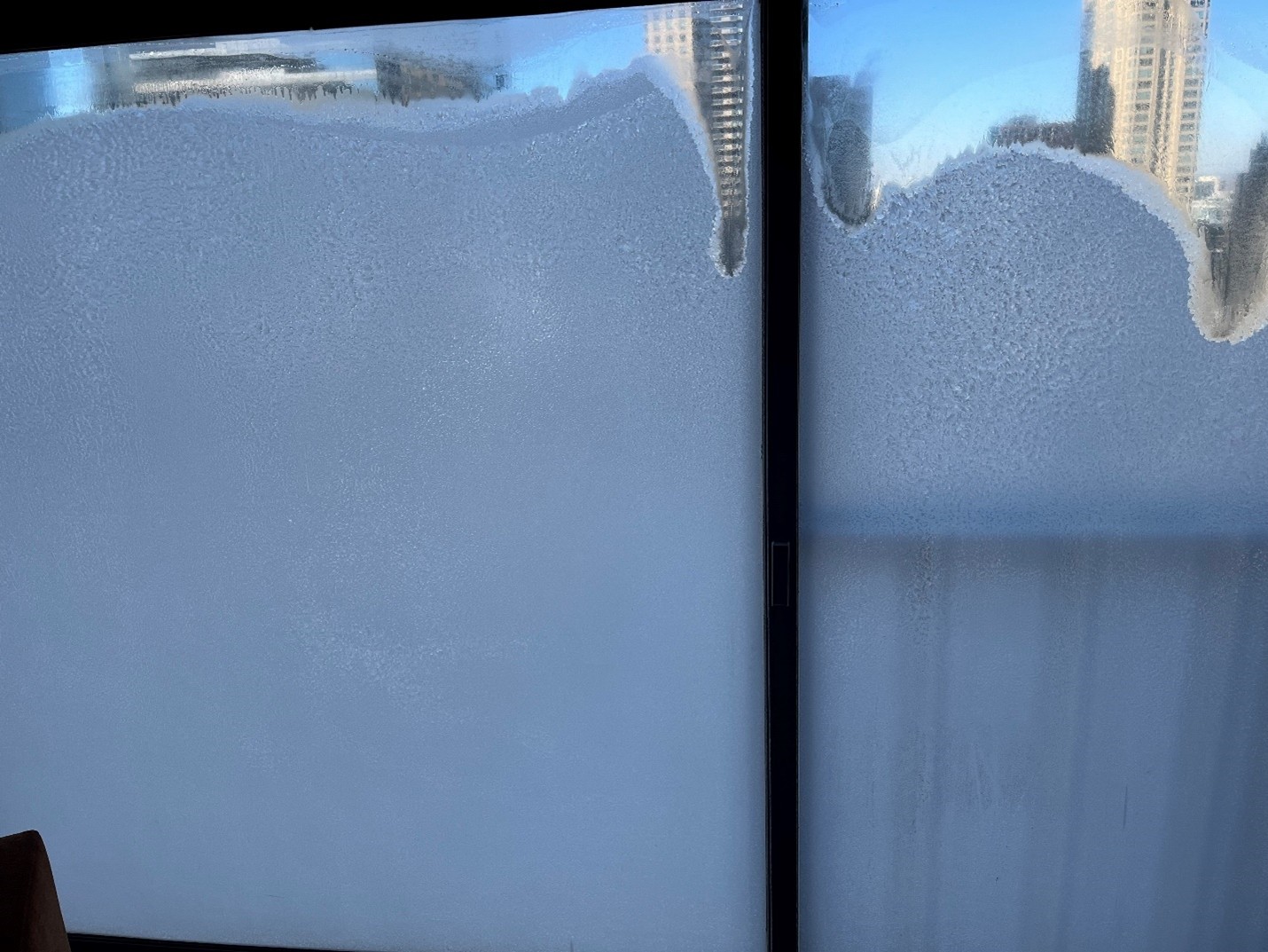 Image shows a window covered in frost.