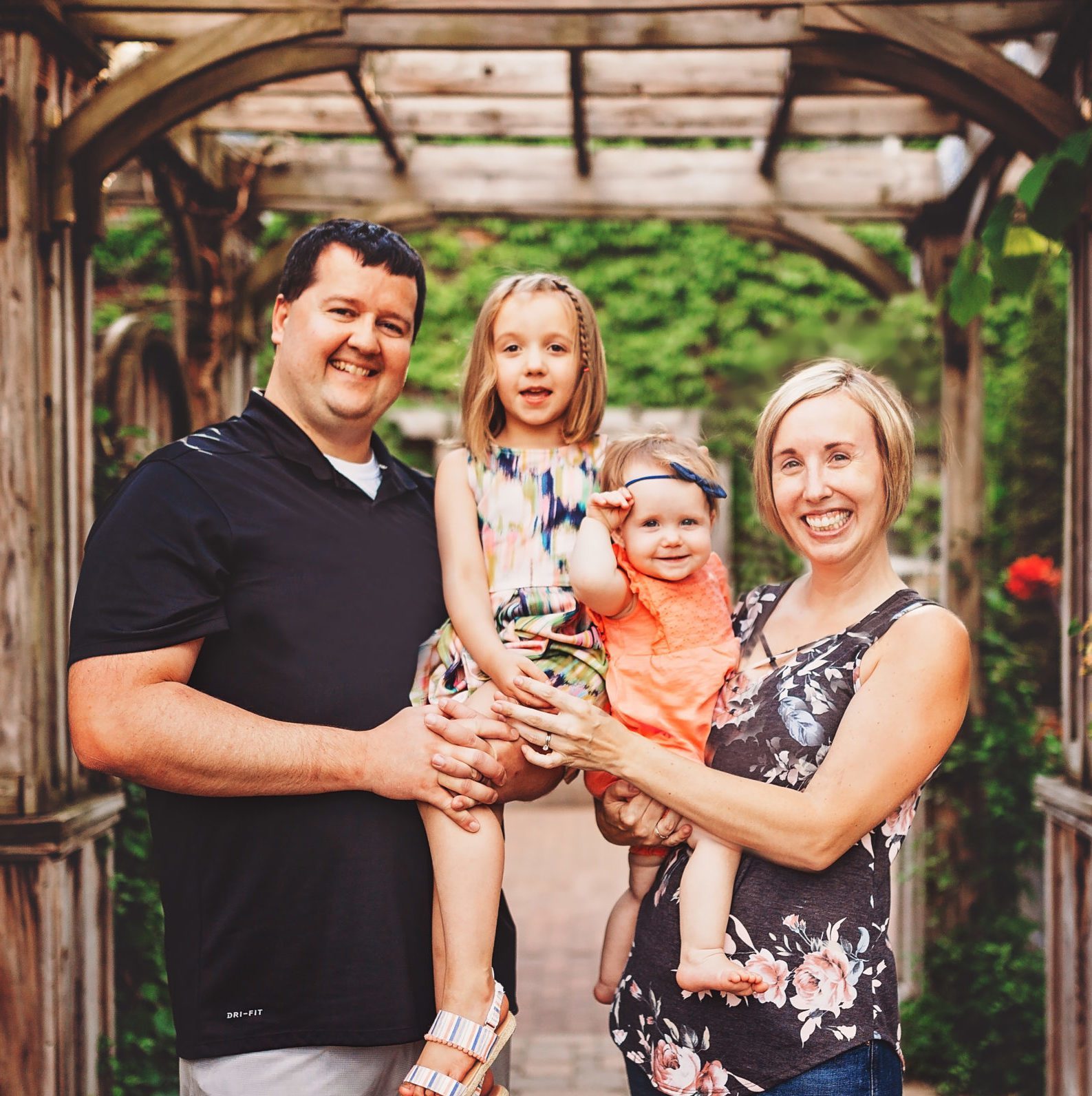 Jen Corcoran man, women and 2 kids smiling for family picture
