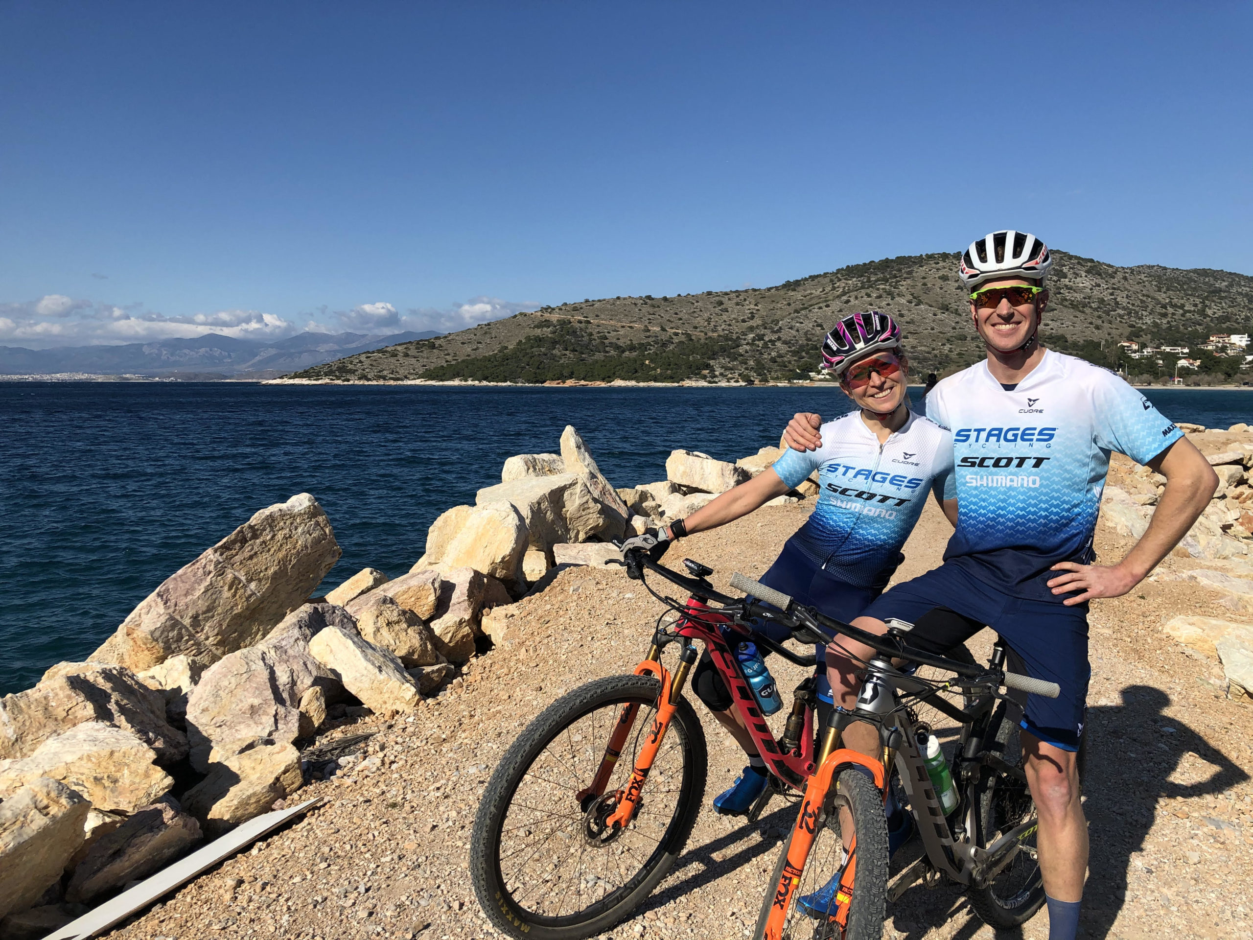 man and women on bikes looking over the ocean