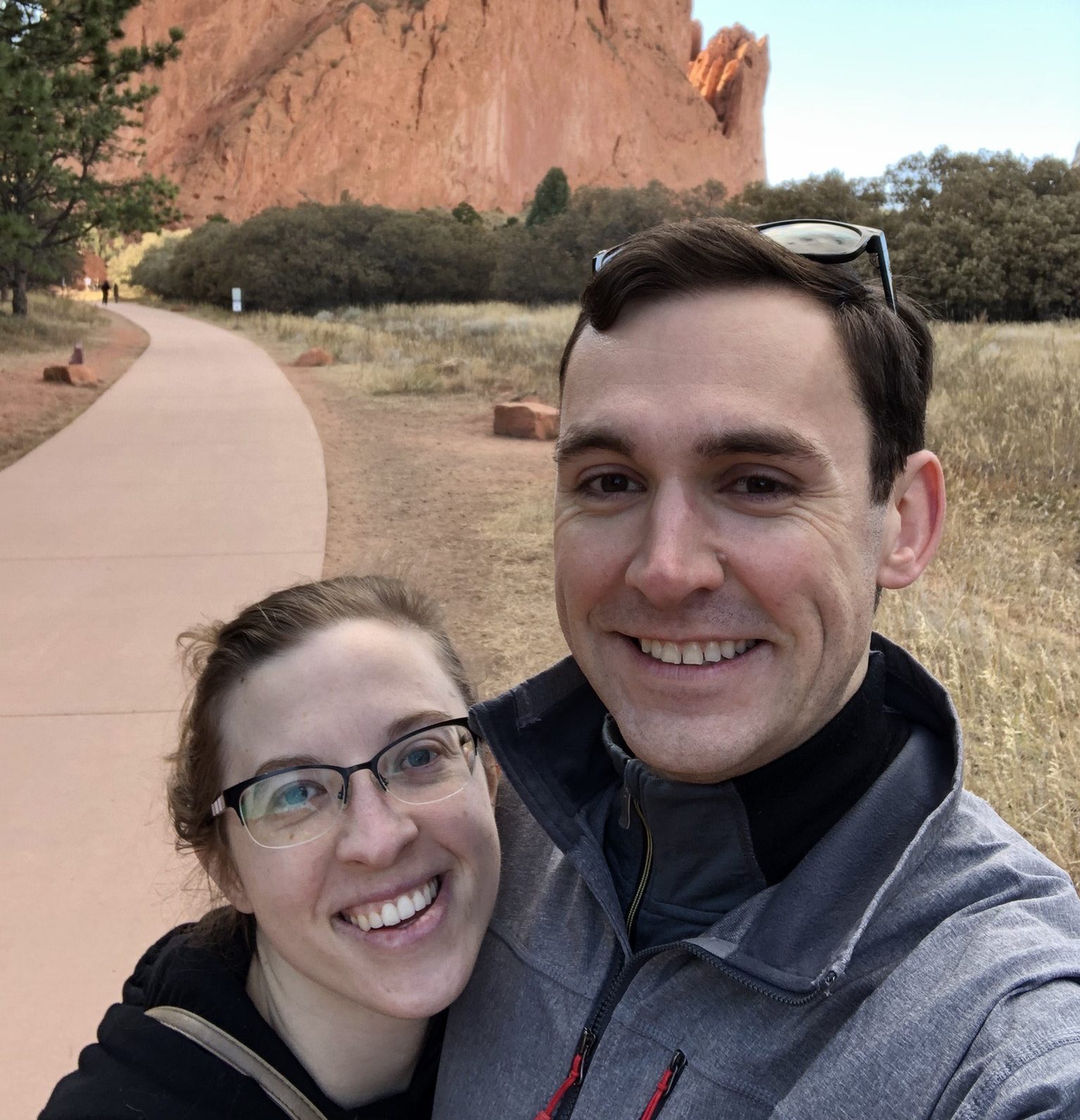 man and women on nature trail smiling for picture
