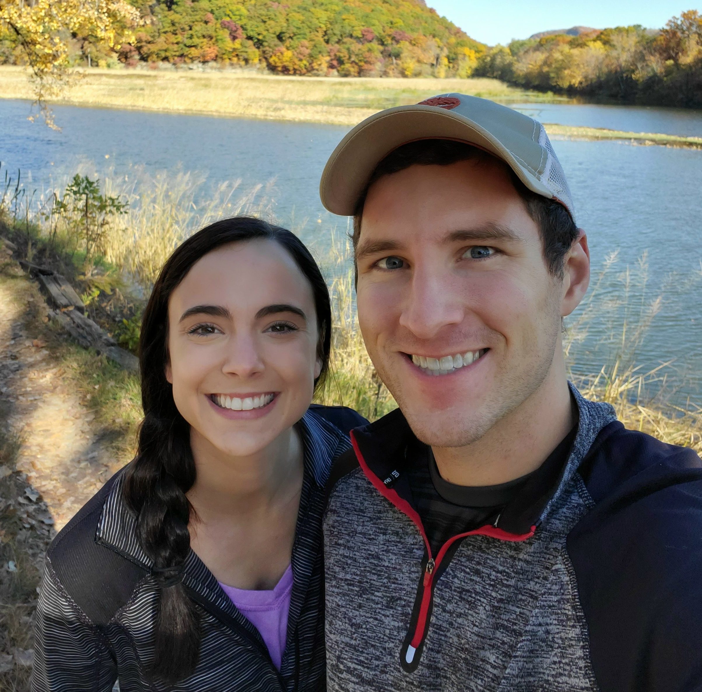 man and women standing by lake
