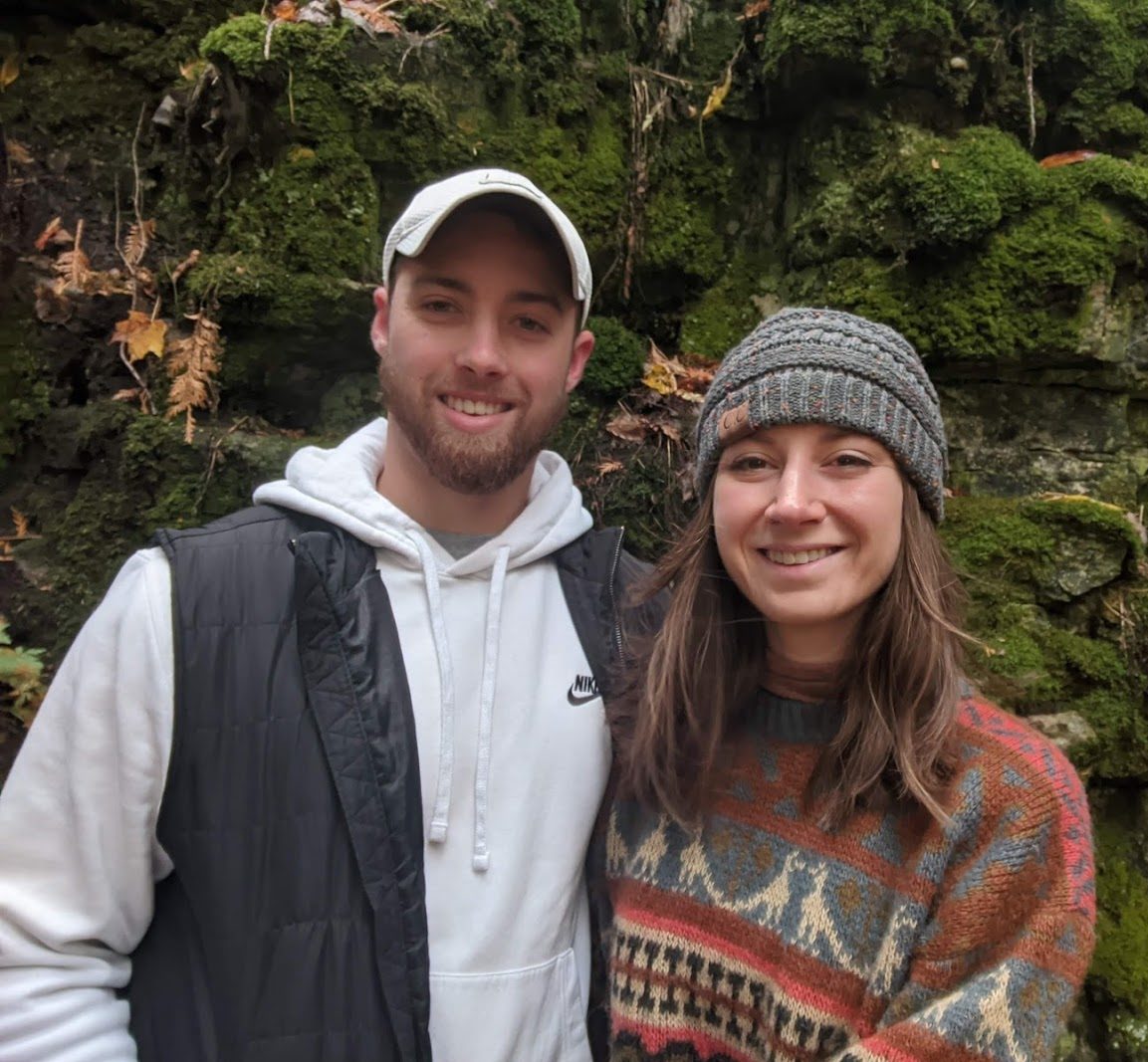 man and women in nature smiling for picture