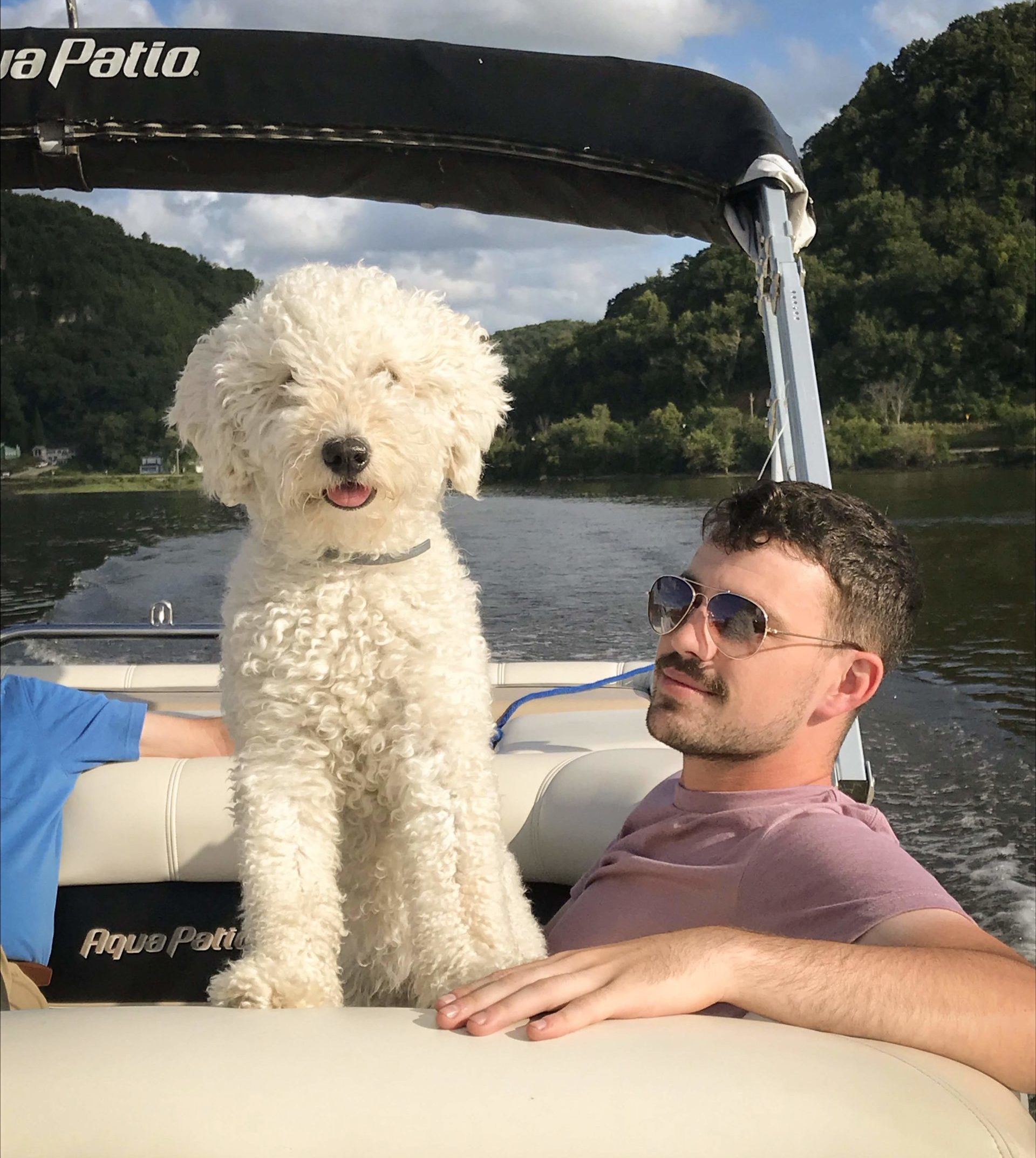 man with dog on boat
