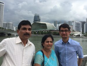 man with parents posing for picture on bridge