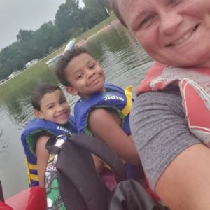 women on boat with kids