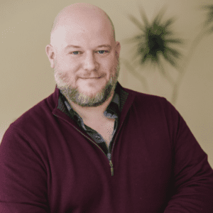 picture of bald man with beard and maroon sweater