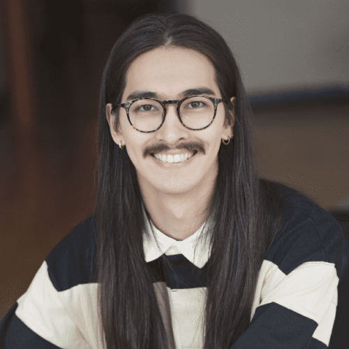 man with glasses, mustache, and long black hair