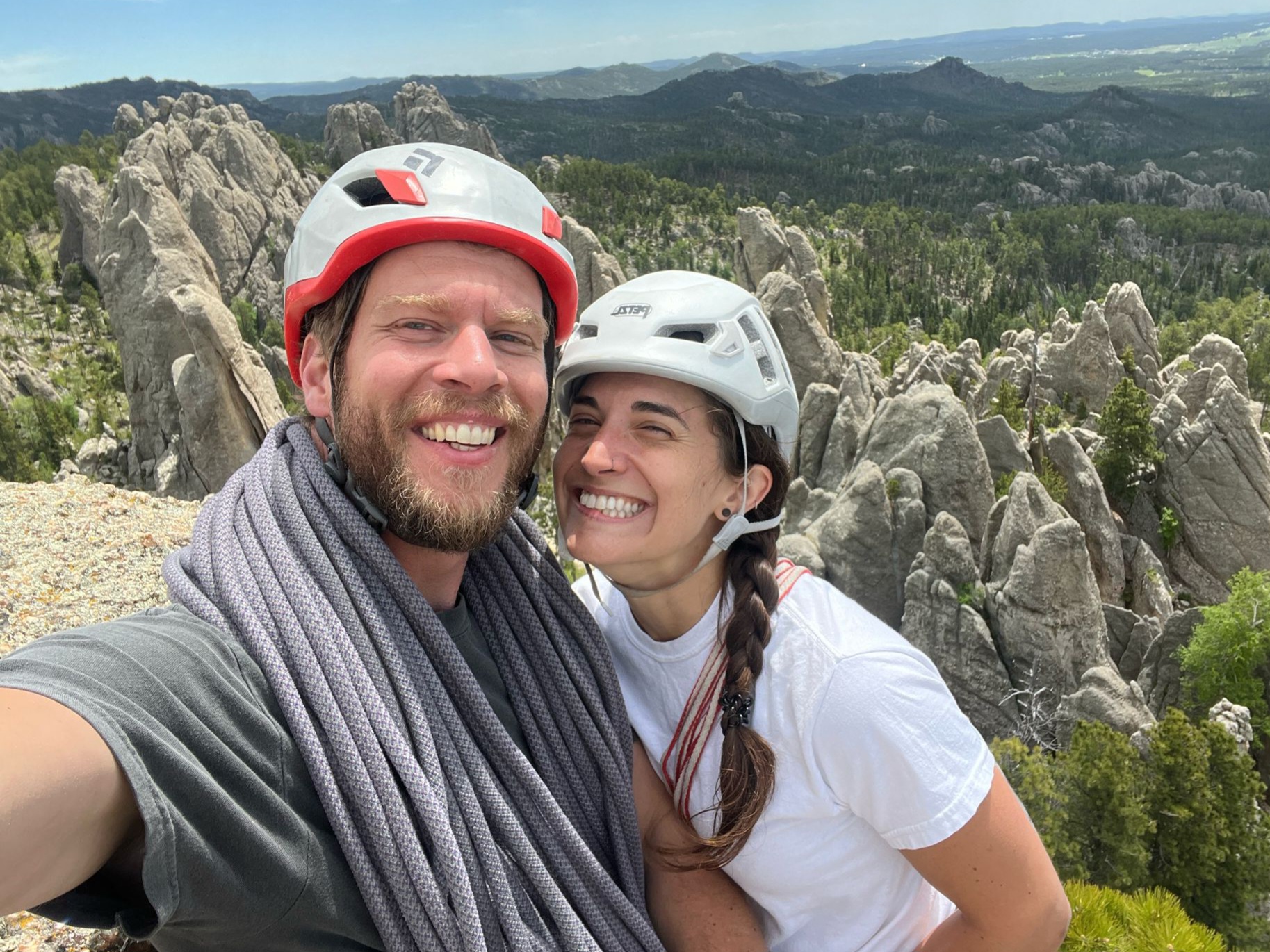 man and women in nature smiling for picture