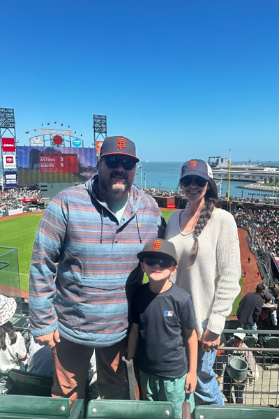 Image shows Kari S and her family at a baseball game.